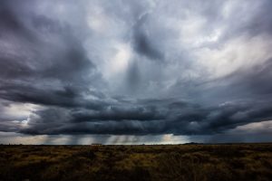 Dangerous power of nature. Gloomy sky over field