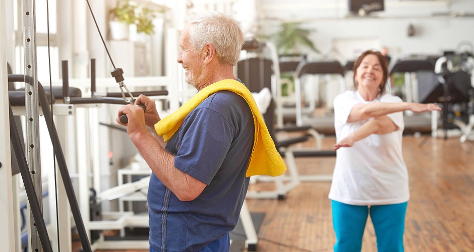 Elderly man working out at fitness center.